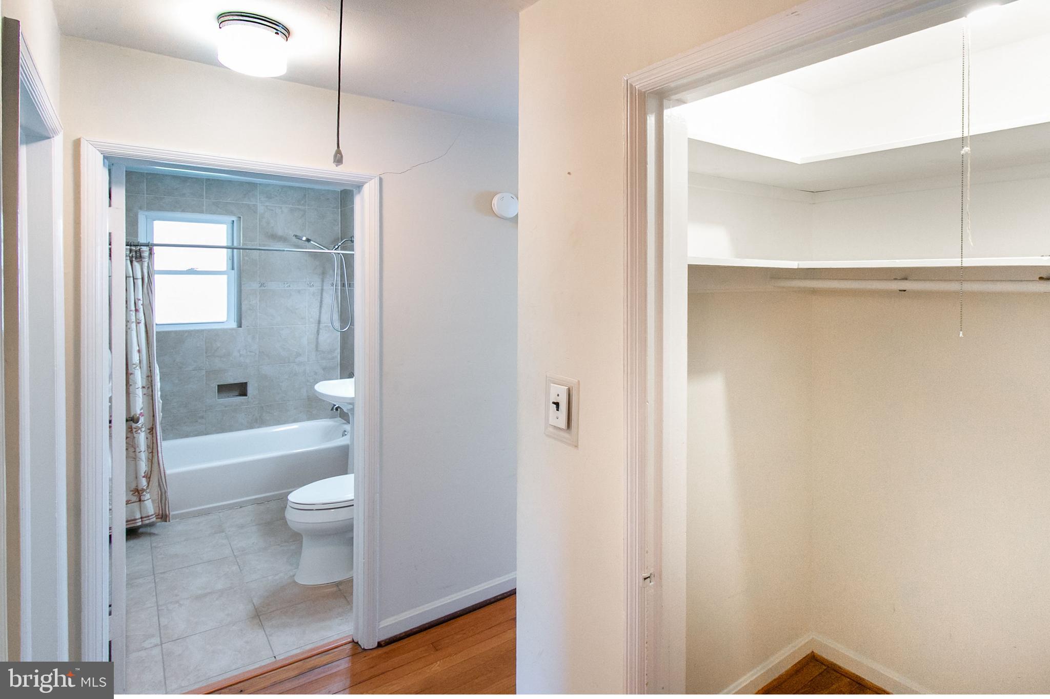 6939 Weston Road Falls Church, VA 22042 - Photo 21 of 25 a bathroom with a granite countertop shower a toilet and a sink