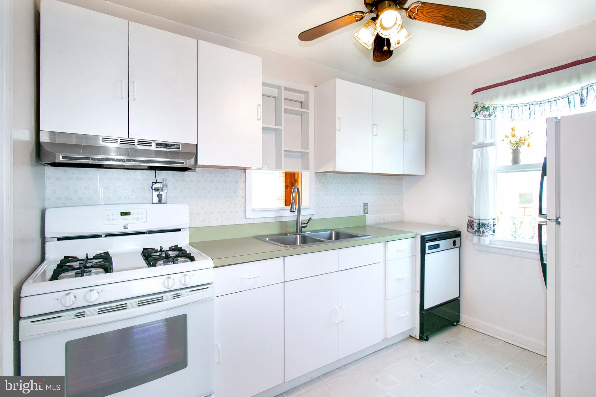 6939 Weston Road Falls Church, VA 22042 - Photo 7 of 25 a kitchen with granite countertop a sink stainless steel appliances and cabinets