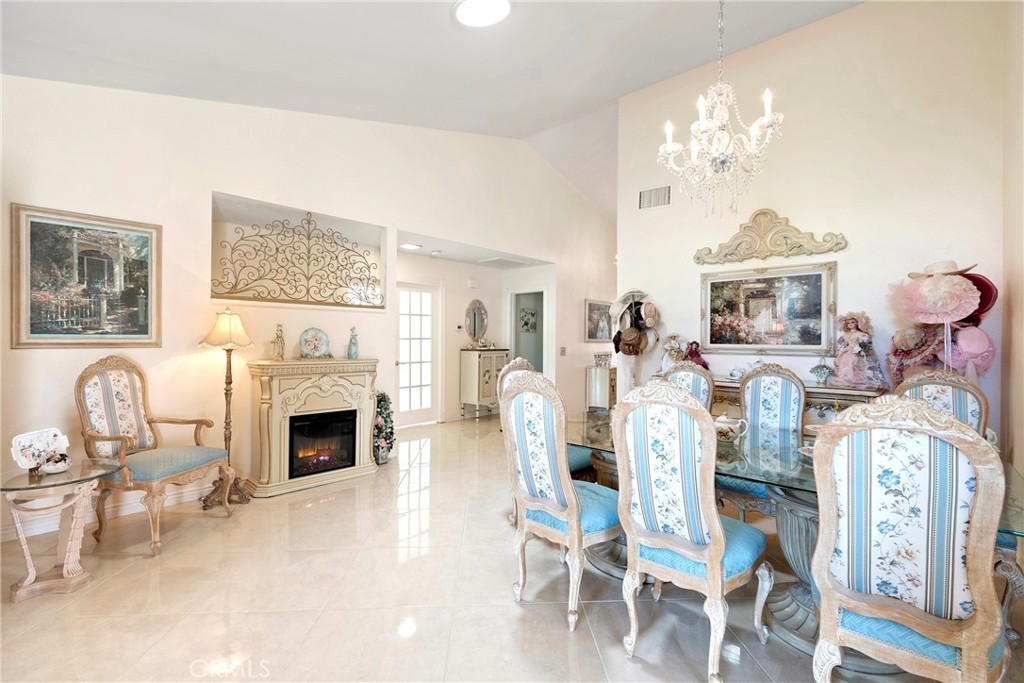 762 Torrey Pines Road Banning, CA 92220 - Photo 11 of 43 a living room with furniture a fireplace and chandelier