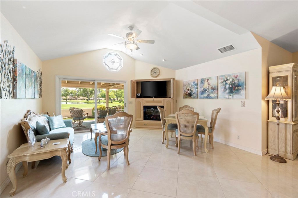 762 Torrey Pines Road Banning, CA 92220 - Photo 12 of 43 a dining room with wooden floor a chandelier fan a glass table and chairs