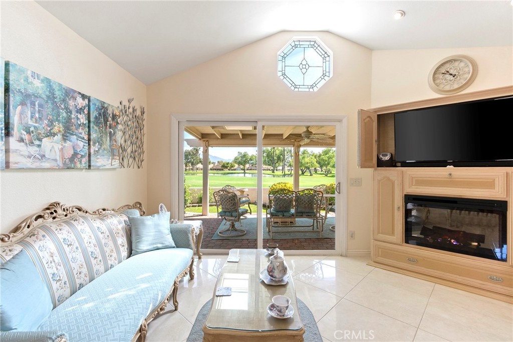 762 Torrey Pines Road Banning, CA 92220 - Photo 14 of 43 a living room with furniture a fireplace and a flat screen tv