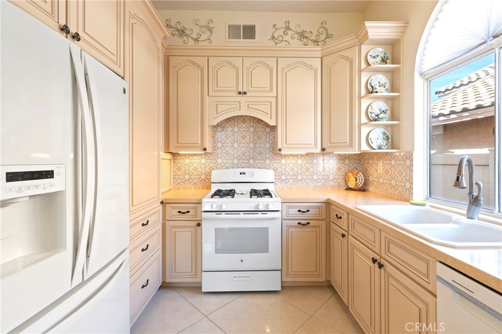 762 Torrey Pines Road Banning, CA 92220 - Photo 17 of 43 a kitchen with cabinets stainless steel appliances and a sink