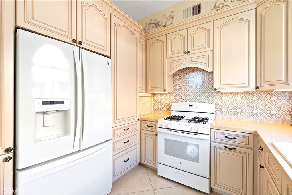 762 Torrey Pines Road Banning, CA 92220 - Photo 19 of 43 a kitchen with granite countertop white cabinets and white appliances