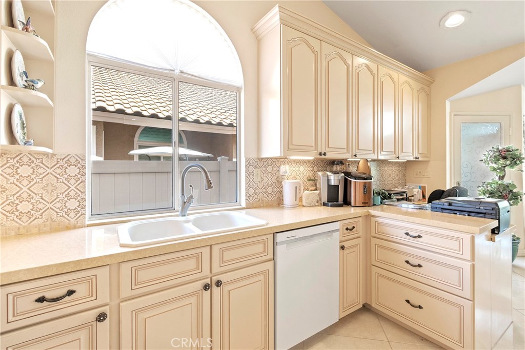 762 Torrey Pines Road Banning, CA 92220 - Photo 20 of 43 a kitchen with cabinets appliances a sink and a window