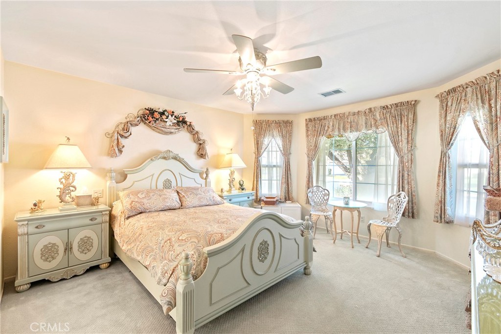 762 Torrey Pines Road Banning, CA 92220 - Photo 22 of 43 a bedroom with a bed and a chandelier