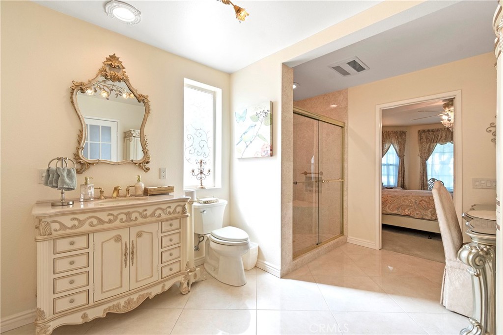 762 Torrey Pines Road Banning, CA 92220 - Photo 24 of 43 a spacious bathroom with a granite countertop sink and a mirror