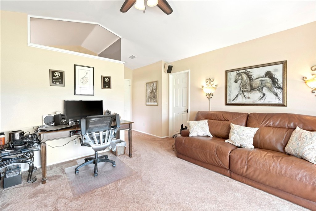 762 Torrey Pines Road Banning, CA 92220 - Photo 31 of 43 a living room with furniture and a flat screen tv