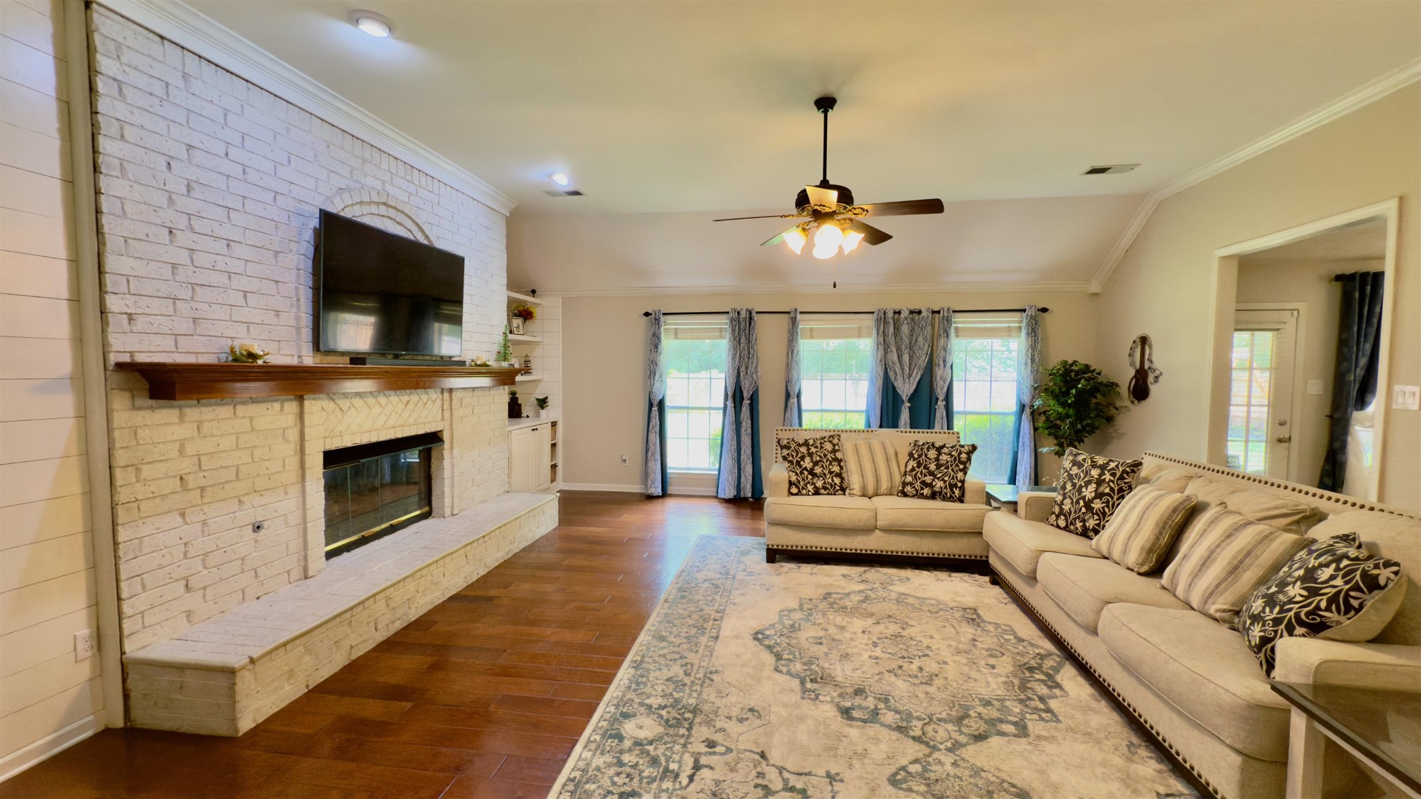 1082 Sugar Lane Collierville, TN 38017 - Photo 4 of 25 a living room with furniture a flat screen tv and a fireplace