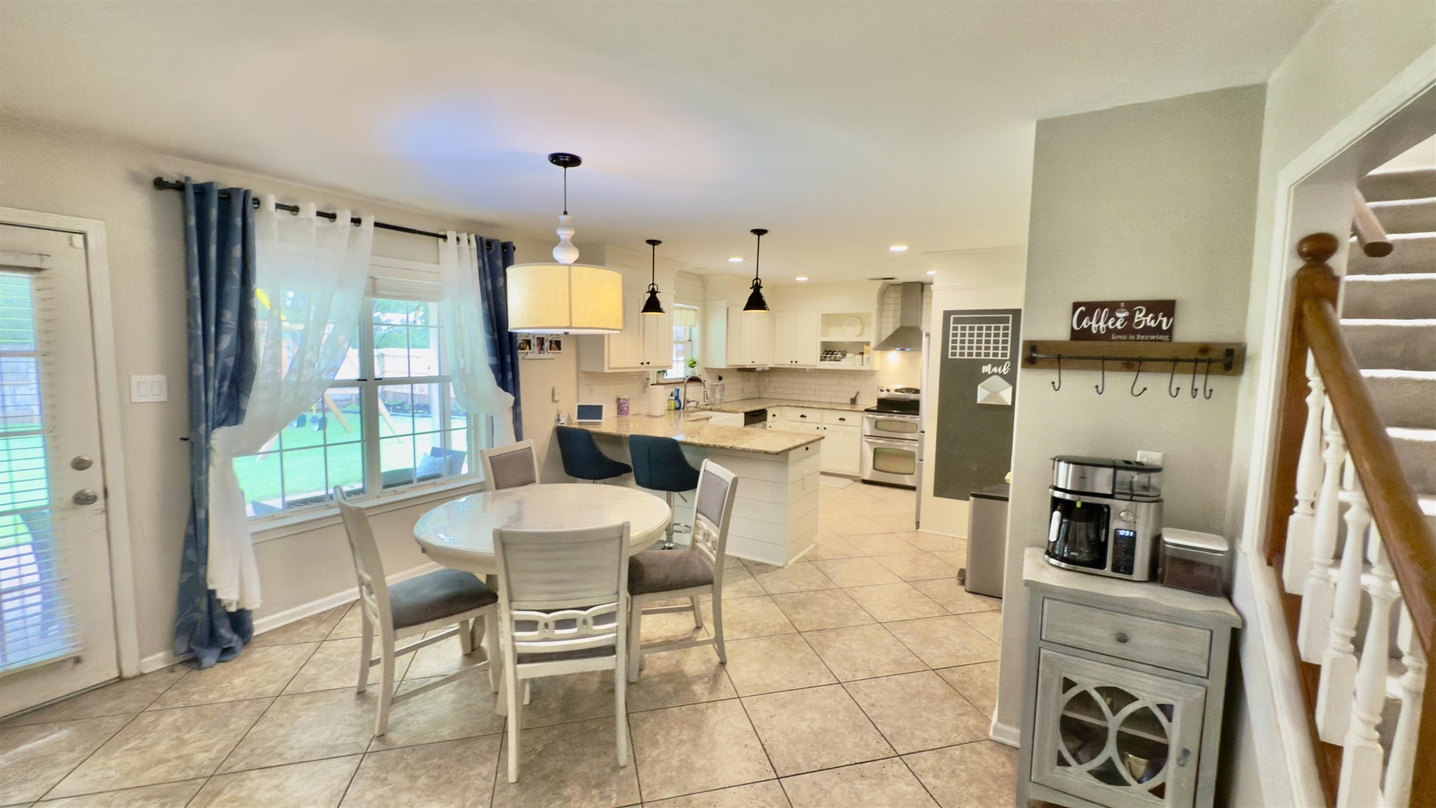 1082 Sugar Lane Collierville, TN 38017 - Photo 8 of 25 a dining room with stainless steel appliances kitchen island granite countertop a table and chairs