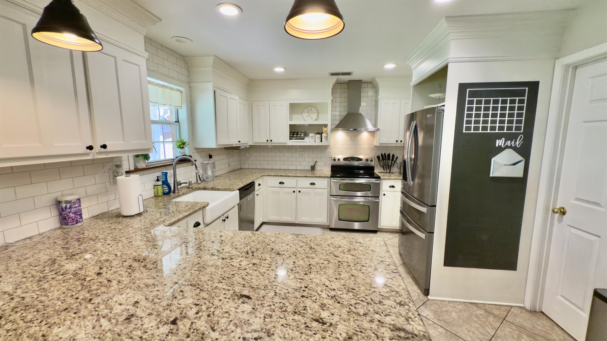 1082 Sugar Lane Collierville, TN 38017 - Photo 10 of 25 a kitchen with stainless steel appliances granite countertop a refrigerator sink stove and white cabinets