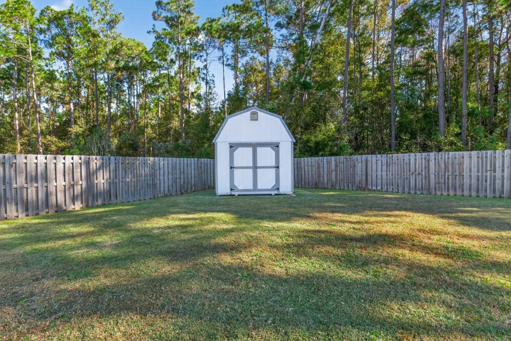 75774 Edwards Road Yulee, FL 32097 - Photo 56 of 70 a swimming pool with wooden fence