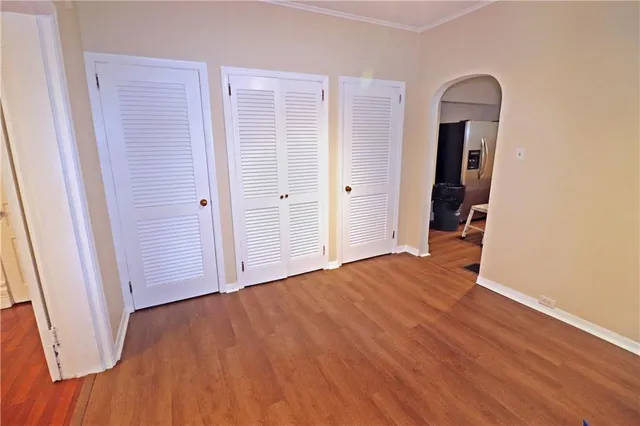 a view of a room with wooden floor and closet