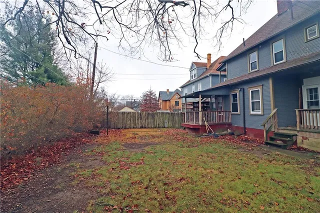 a view of a house with a yard and sitting area