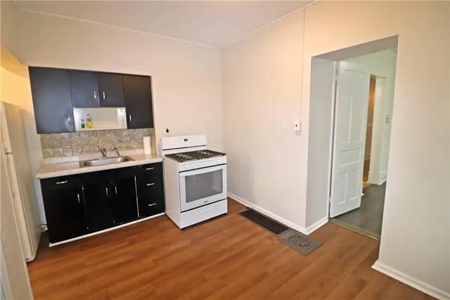 a kitchen with a stove and a refrigerator