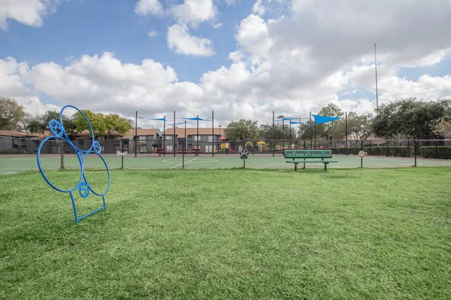 a view of a playground with basketball court
