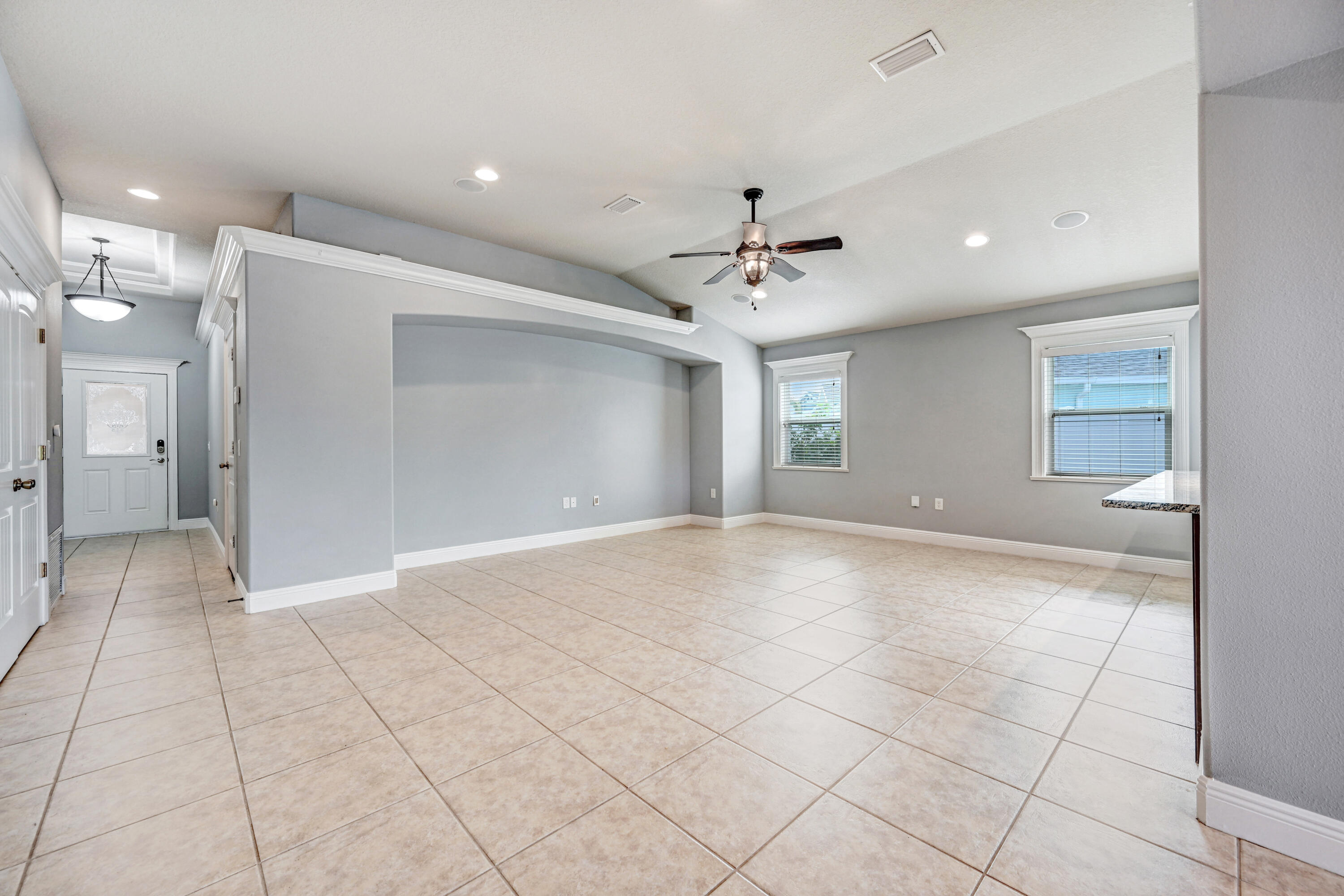 3901 Brantley Circle Rockledge, FL 32955 - Photo 18 of 33 a view of an empty room and window and chandelier fan