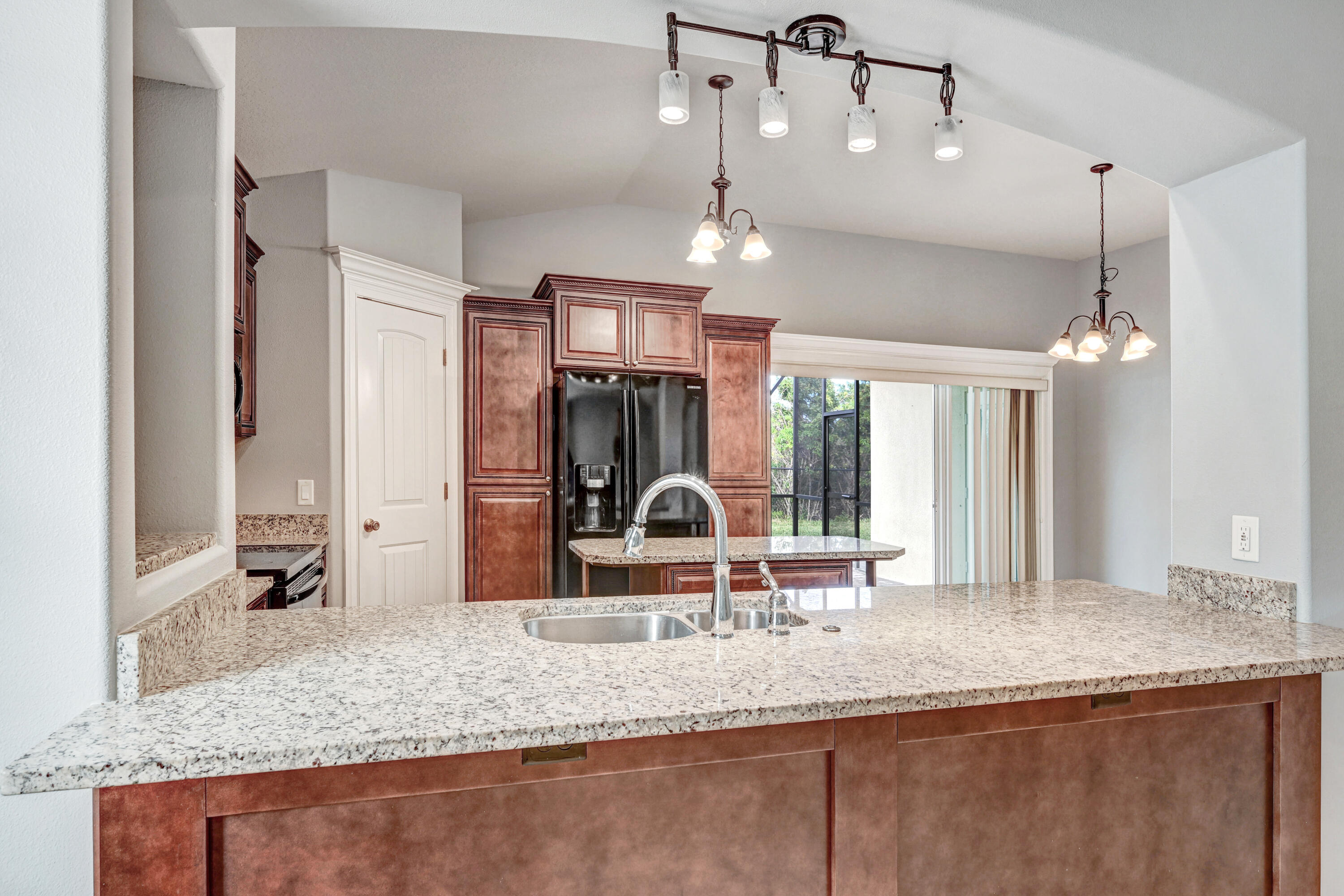 3901 Brantley Circle Rockledge, FL 32955 - Photo 19 of 33 a large kitchen with granite countertop a sink a counter space appliances and cabinets