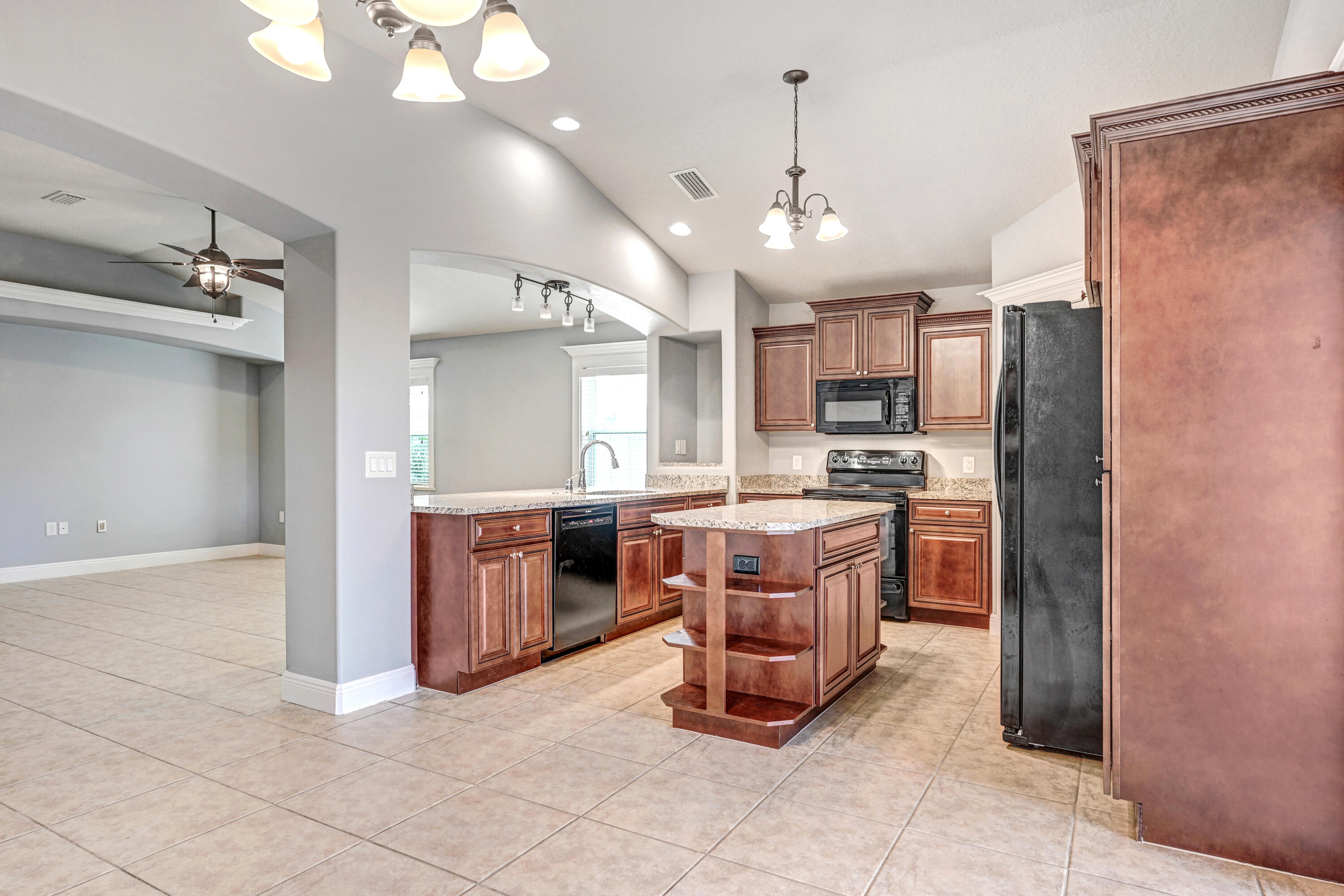 3901 Brantley Circle Rockledge, FL 32955 - Photo 21 of 33 a kitchen with a refrigerator a sink dishwasher a oven with a dining table and chairs