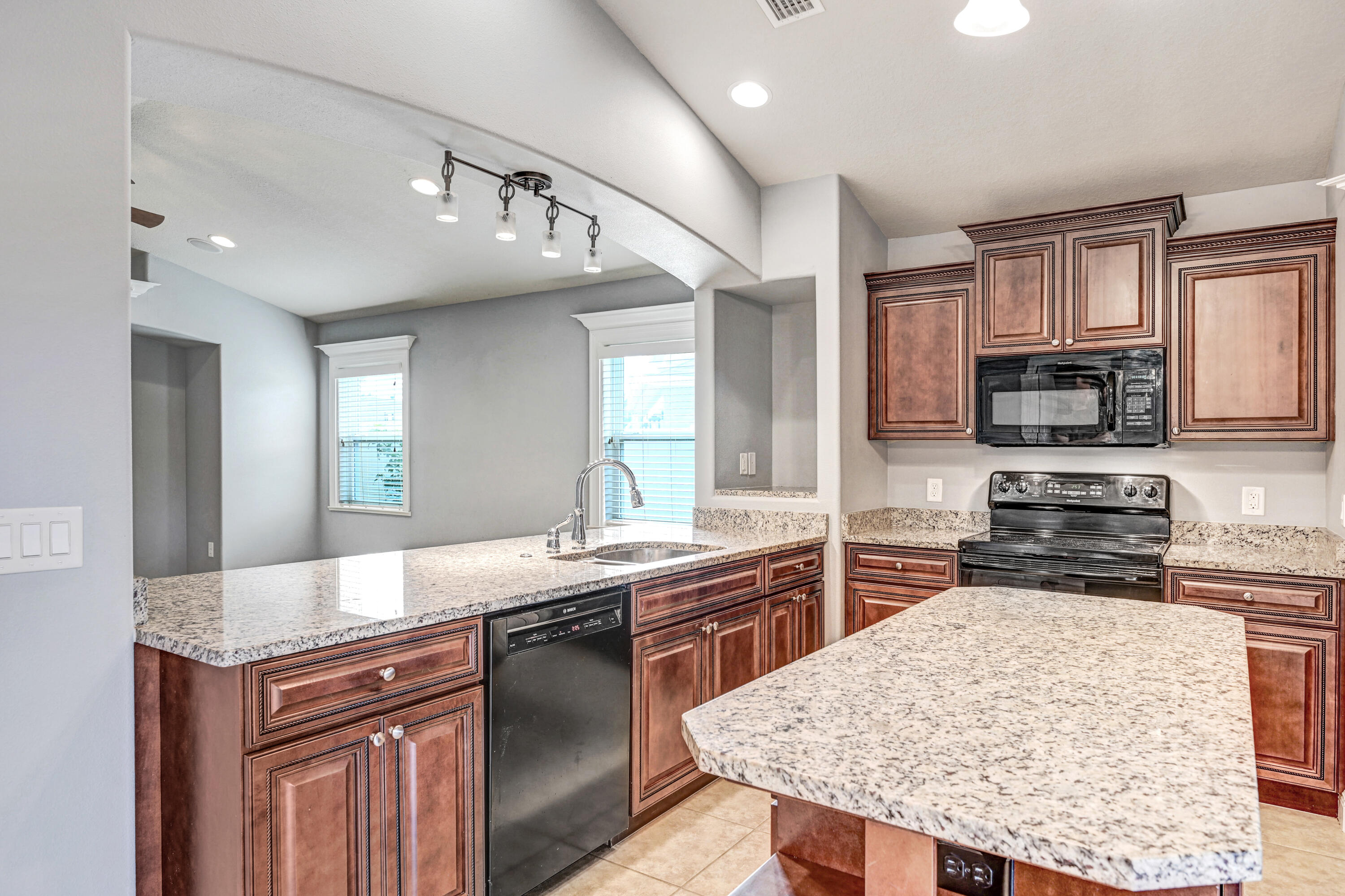 3901 Brantley Circle Rockledge, FL 32955 - Photo 22 of 33 a kitchen with stainless steel appliances granite countertop a sink stove and refrigerator