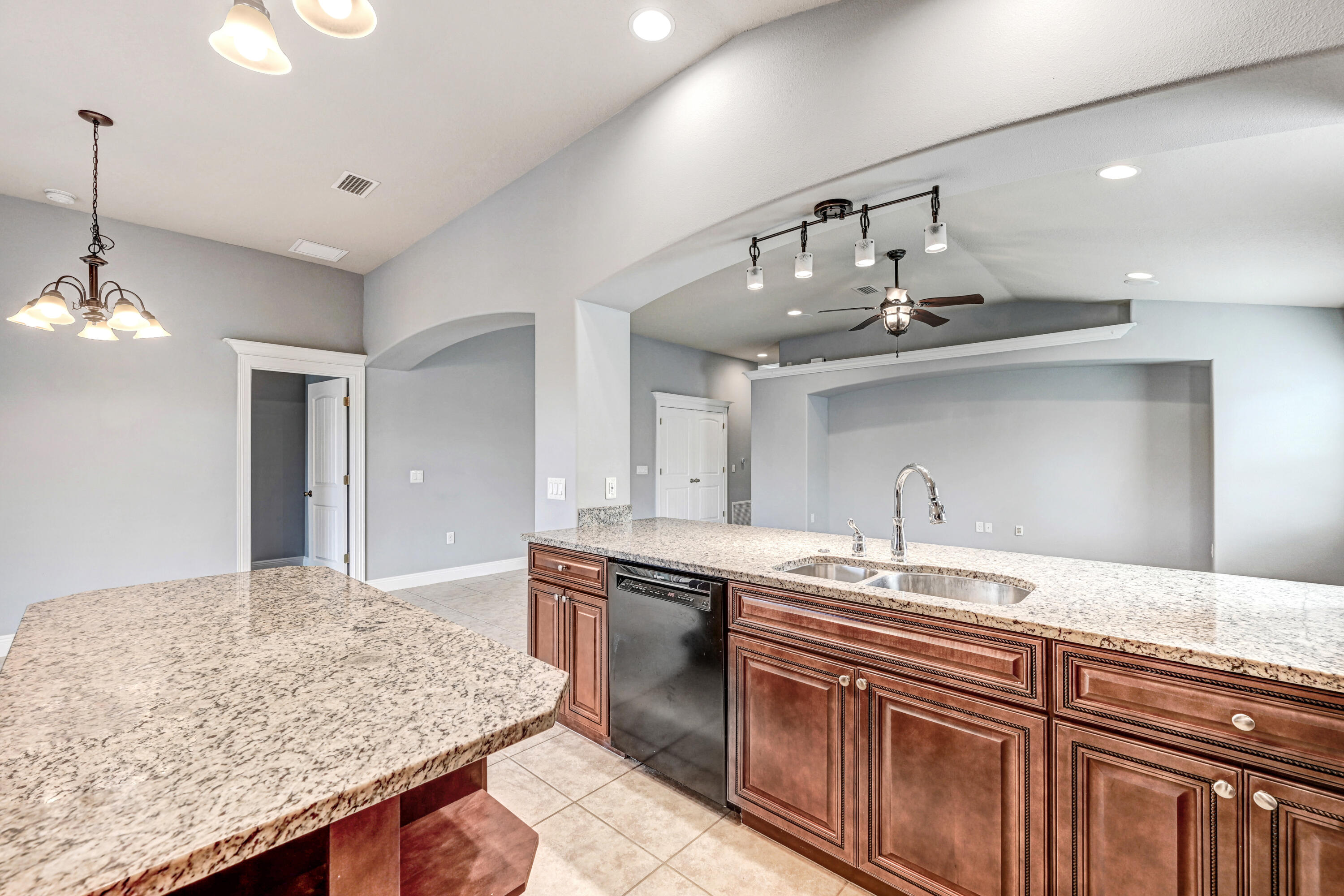 3901 Brantley Circle Rockledge, FL 32955 - Photo 25 of 33 a kitchen with kitchen island granite countertop a sink and chandelier
