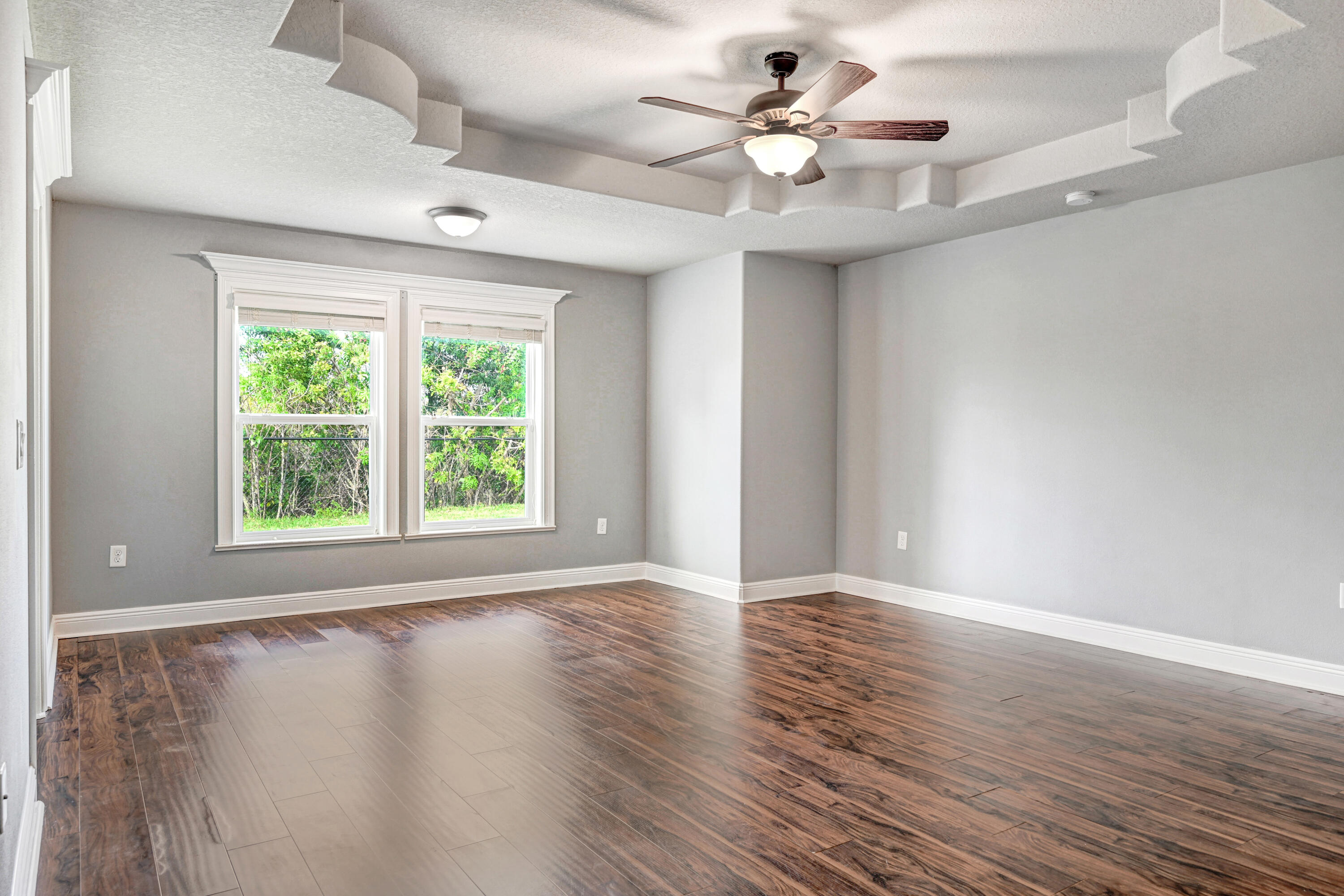 3901 Brantley Circle Rockledge, FL 32955 - Photo 27 of 33 a view of an empty room with wooden floor and a window