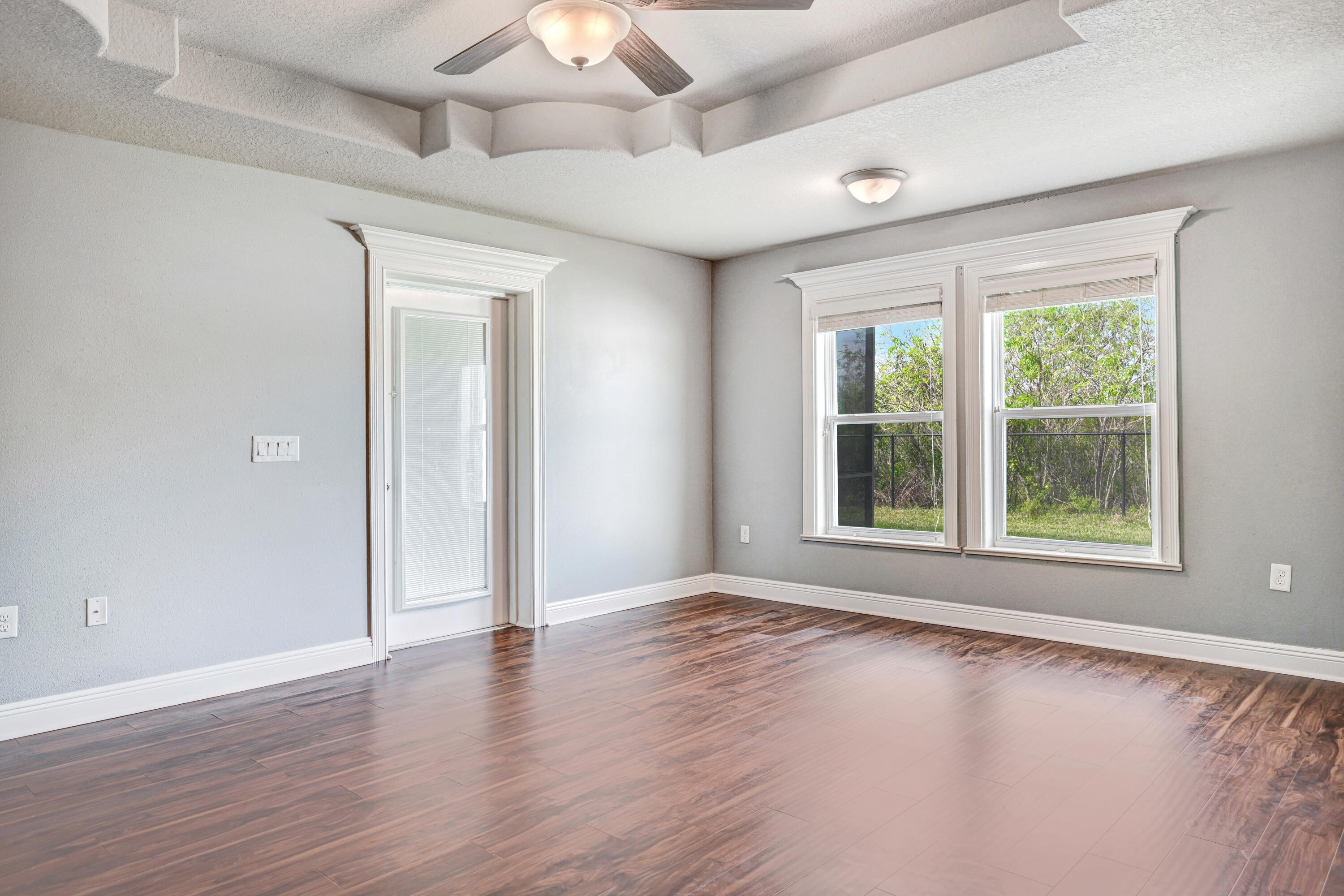 3901 Brantley Circle Rockledge, FL 32955 - Photo 28 of 33 an empty room with wooden floor and windows