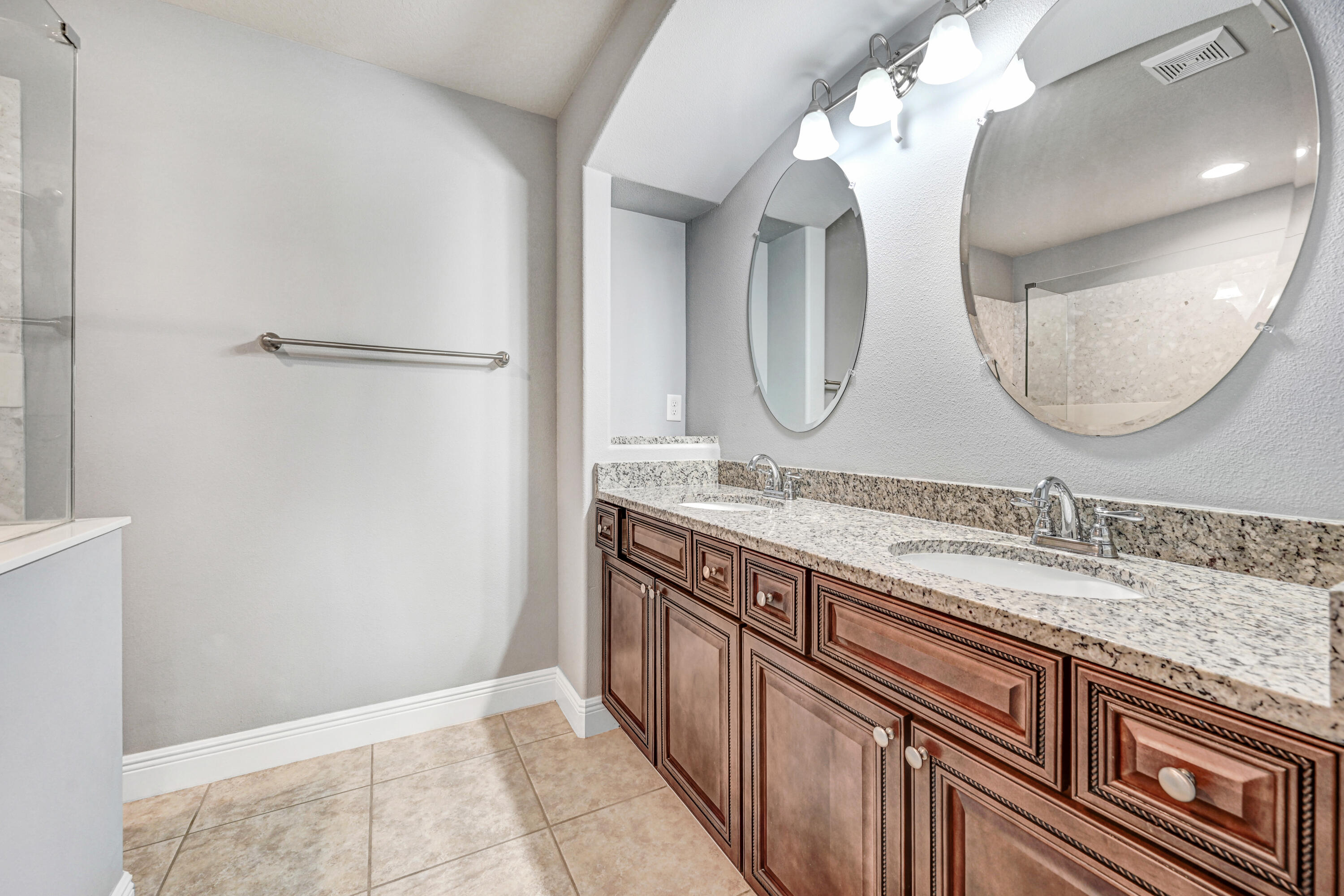 3901 Brantley Circle Rockledge, FL 32955 - Photo 30 of 33 a bathroom with a granite countertop double vanity sink and a mirror