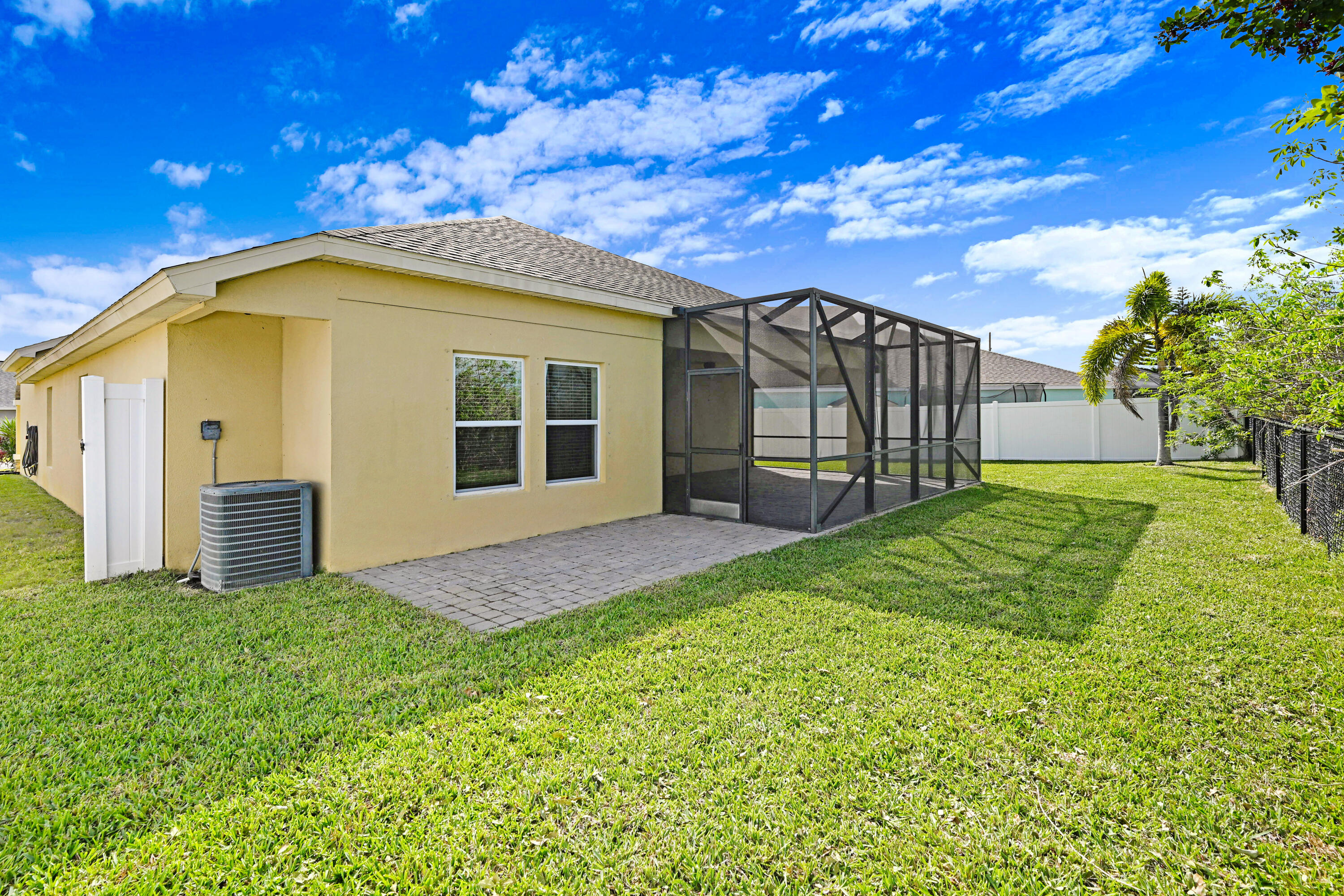 3901 Brantley Circle Rockledge, FL 32955 - Photo 3 of 33 a view of a backyard with brick wall and a large tree