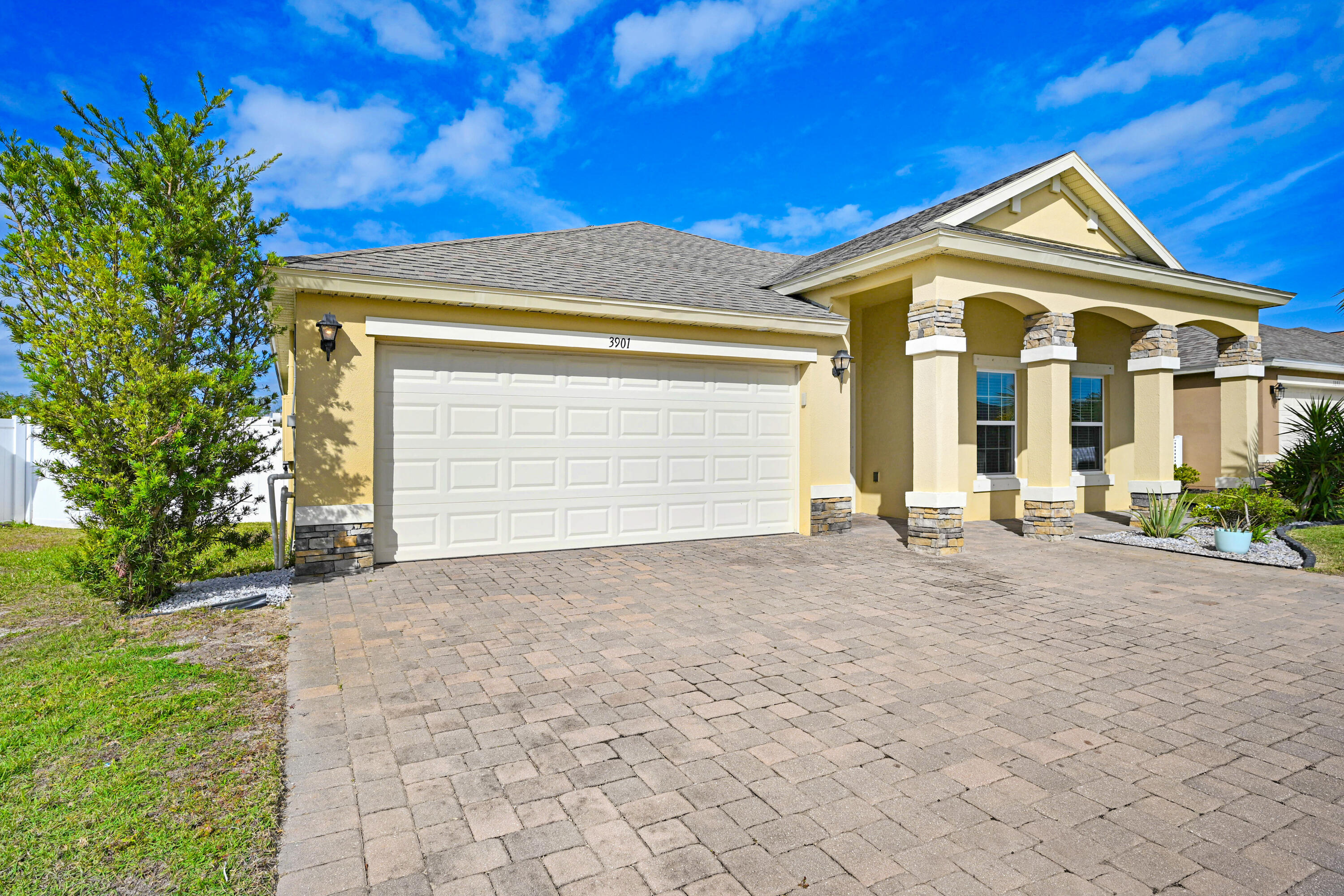 3901 Brantley Circle Rockledge, FL 32955 - Photo 8 of 33 a front view of a house with a yard and garage