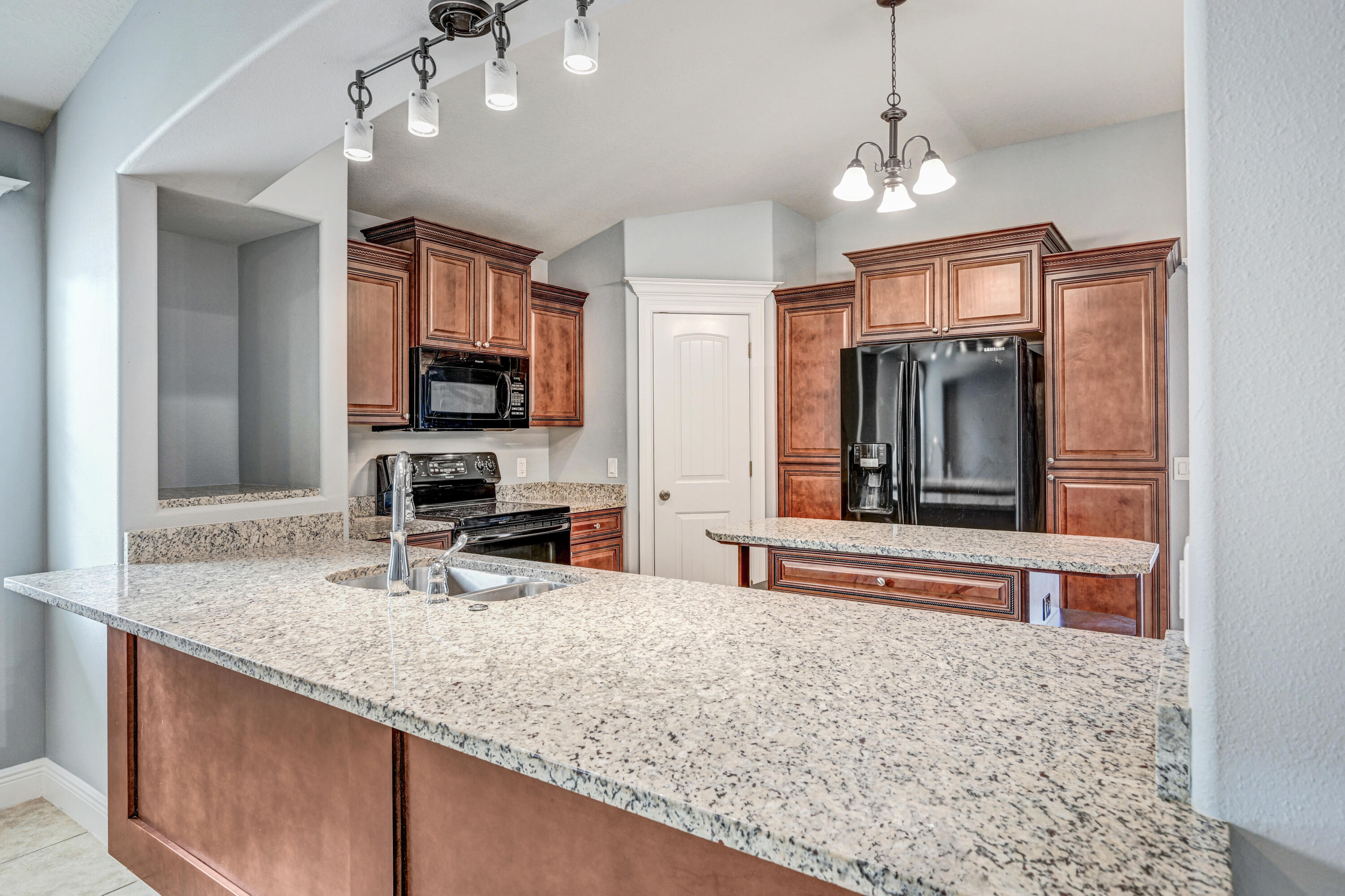 3901 Brantley Circle Rockledge, FL 32955 - Photo 10 of 33 a kitchen with stainless steel appliances granite countertop a sink refrigerator and microwave