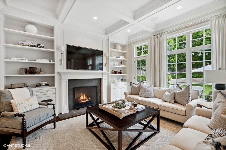 844 Prospect Avenue Winnetka, IL 60093 - Photo 11 of 27 a living room with furniture a flat screen tv and a fireplace