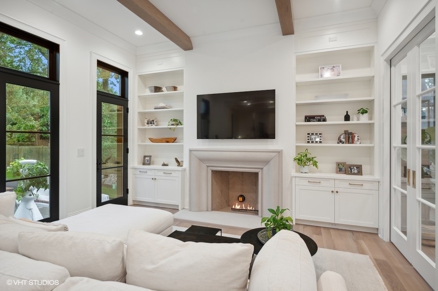 844 Prospect Avenue Winnetka, IL 60093 - Photo 10 of 27 a living room with furniture a flat screen tv and a fireplace