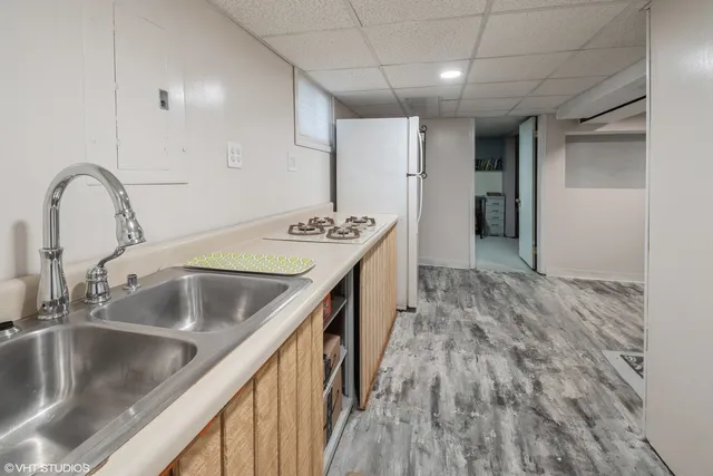 a kitchen with a sink and a refrigerator