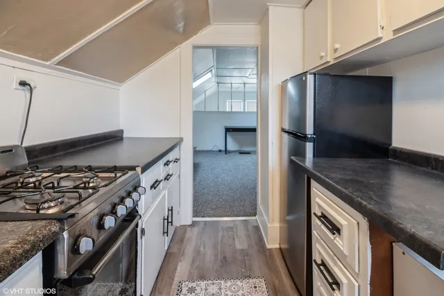 a kitchen with stainless steel appliances granite countertop a stove and a refrigerator