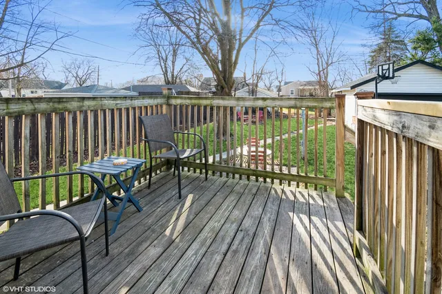 a view of balcony with wooden floor and outdoor seating