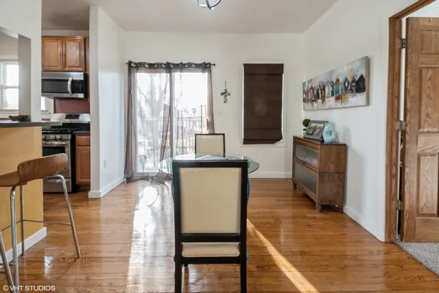 a living room with furniture a large window and wood floor