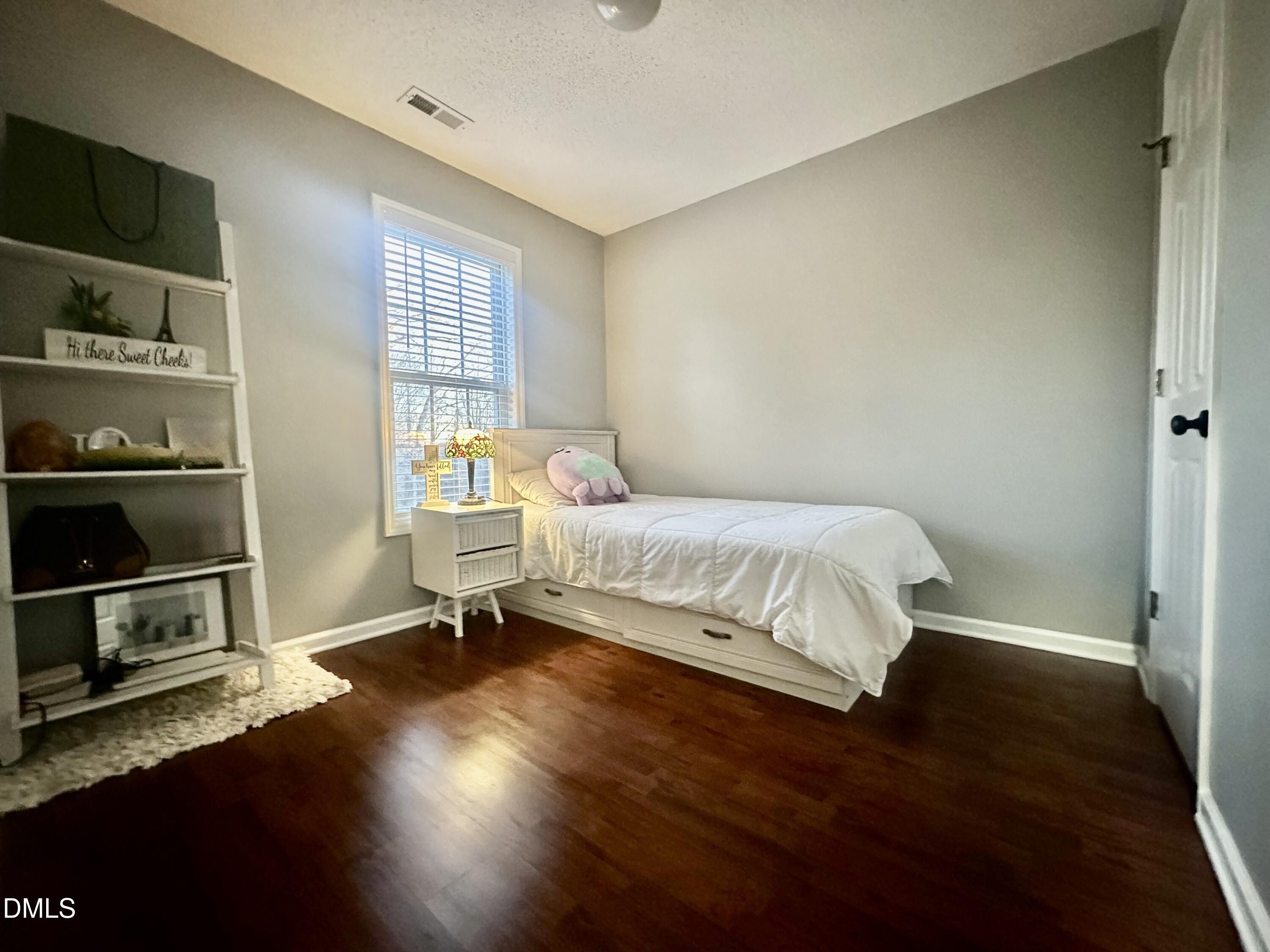2106 Walnut Bluffs Lane Raleigh, NC 27610 - Photo 11 of 15 a bedroom with a bed and a window