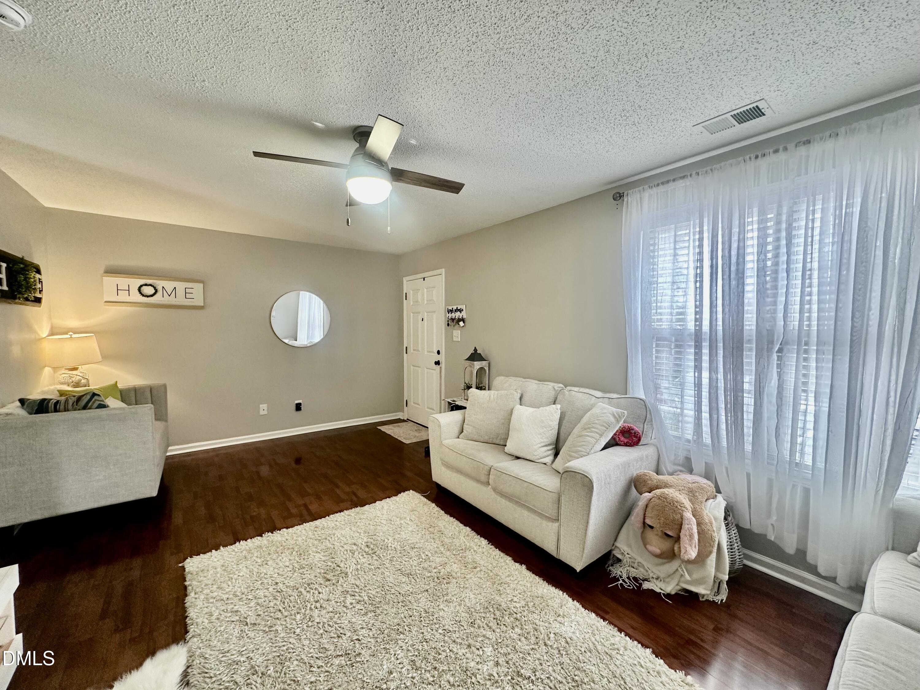 2106 Walnut Bluffs Lane Raleigh, NC 27610 - Photo 4 of 15 a living room with furniture and a chandelier