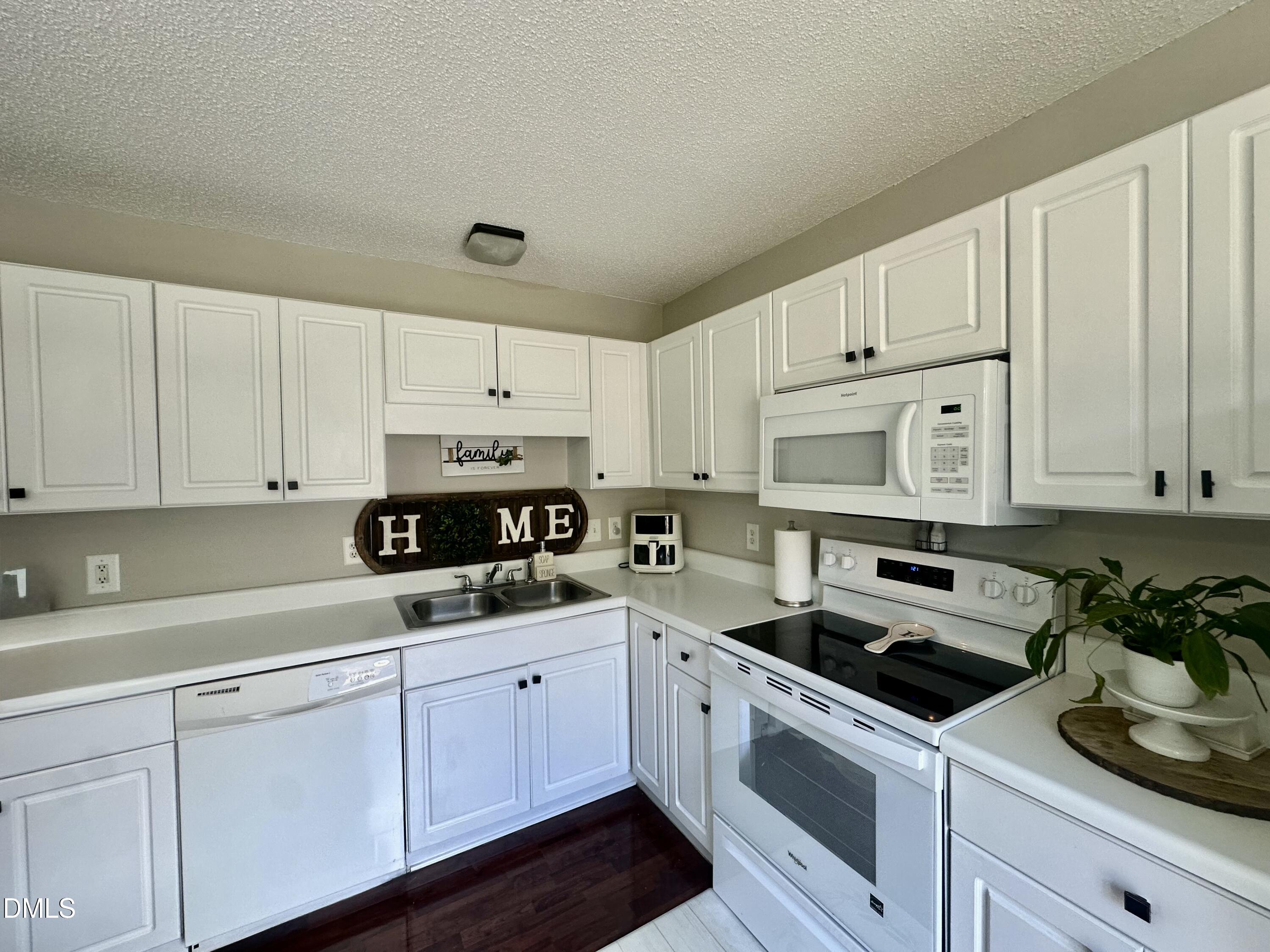 2106 Walnut Bluffs Lane Raleigh, NC 27610 - Photo 7 of 15 a kitchen with cabinets white stainless steel appliances and sink