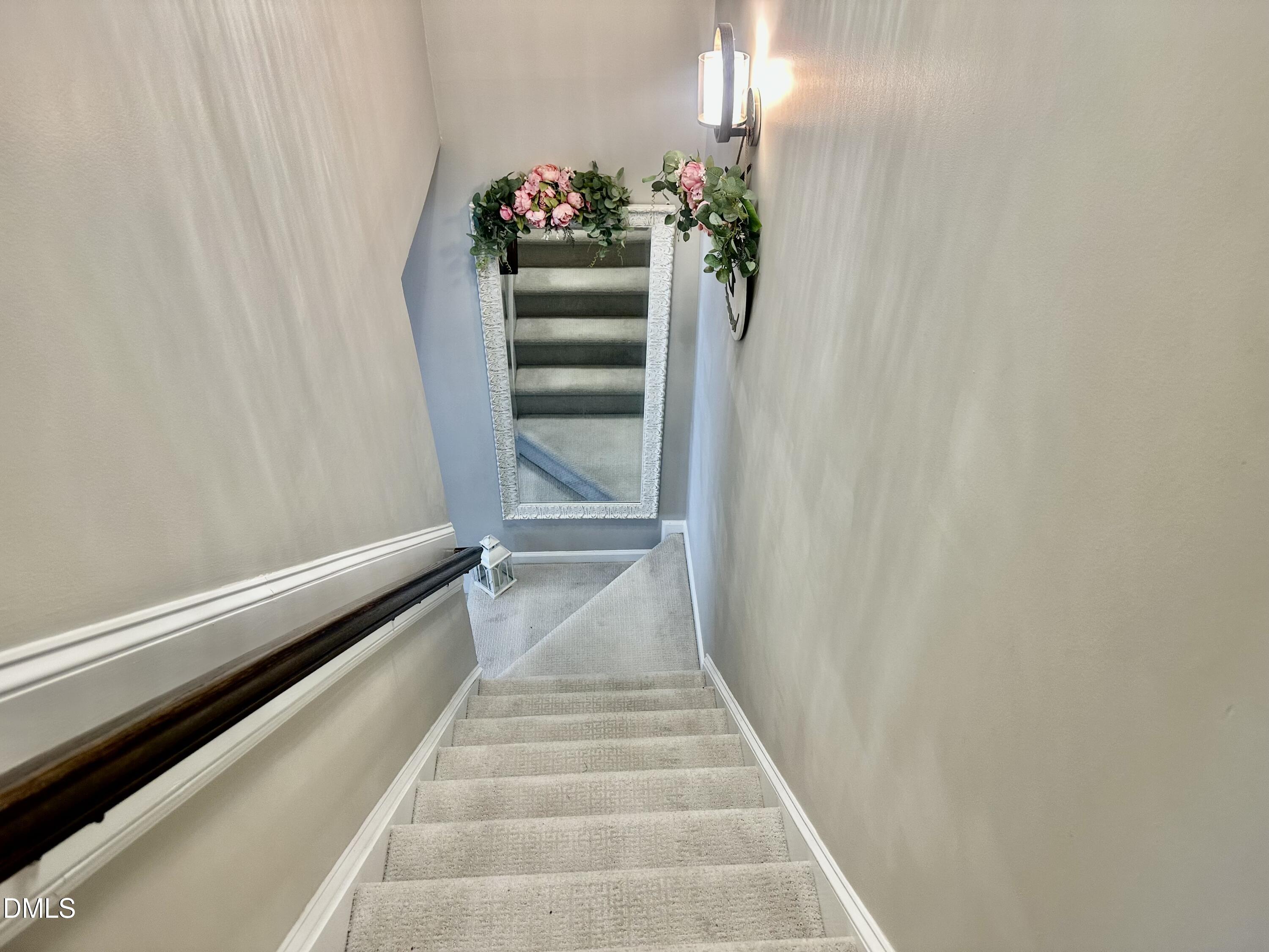 2106 Walnut Bluffs Lane Raleigh, NC 27610 - Photo 9 of 15 a view of a hallway with wooden floor and stairs