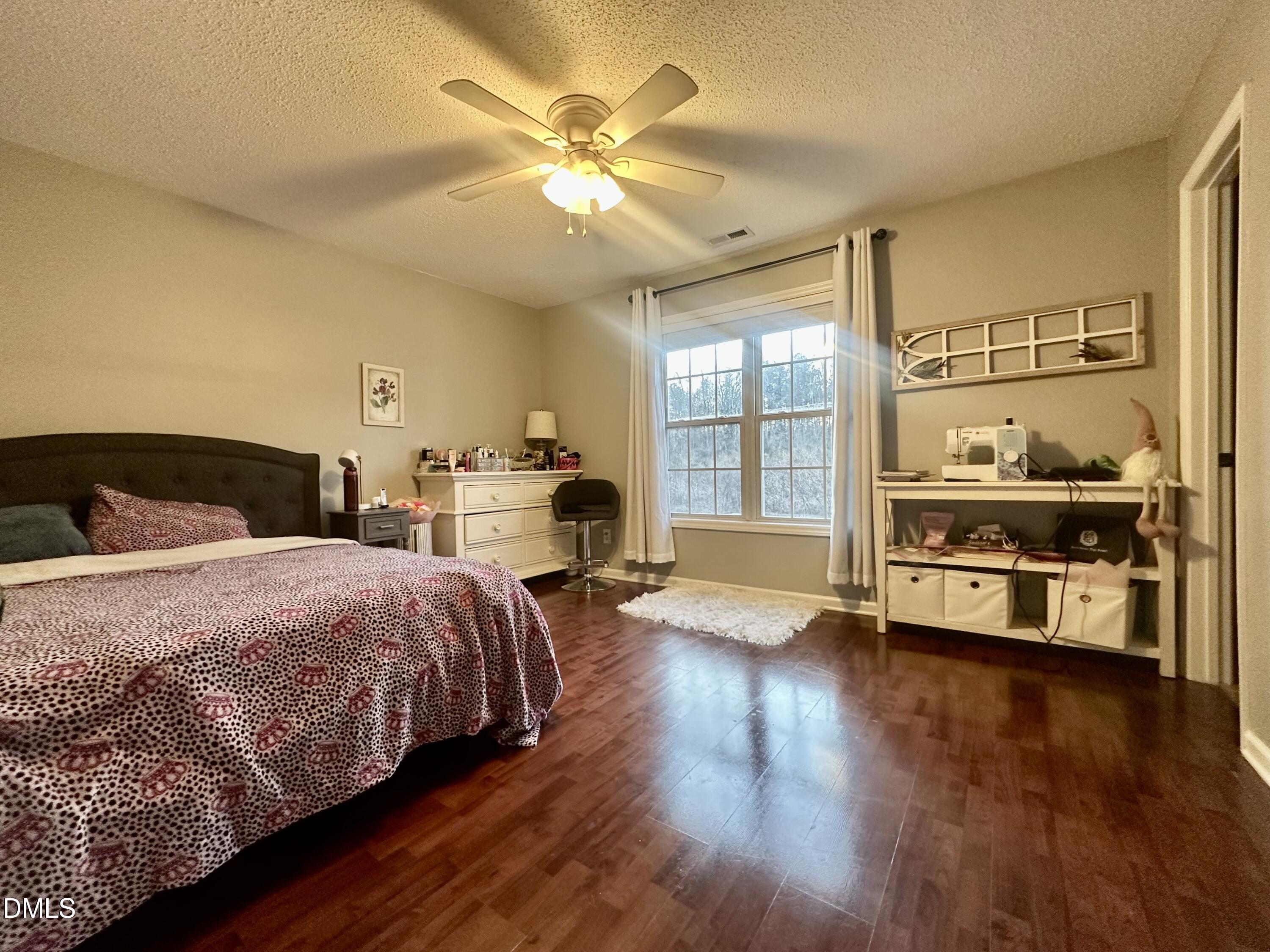 2106 Walnut Bluffs Lane Raleigh, NC 27610 - Photo 10 of 15 a bedroom with a bed and wooden floor