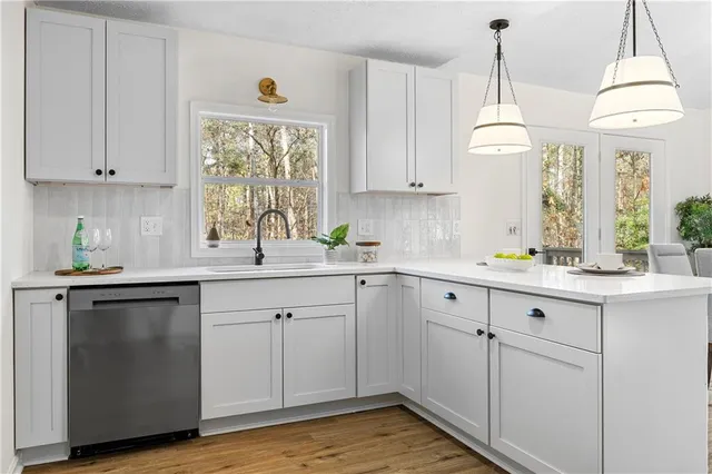a kitchen with stainless steel appliances a stove a microwave and cabinets