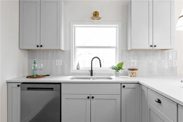a kitchen with a table chandelier and fireplace