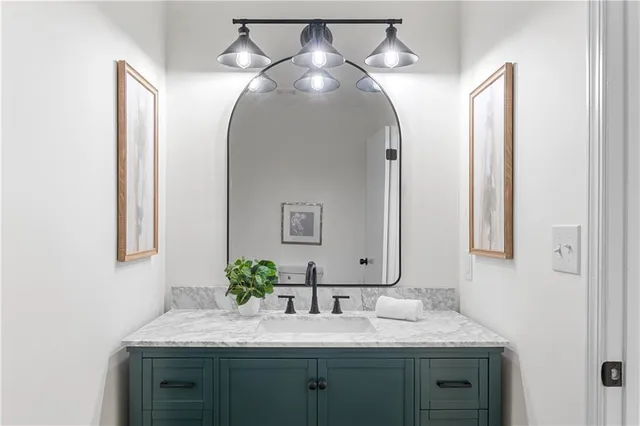 a bathroom with a granite countertop toilet a sink and bathtub