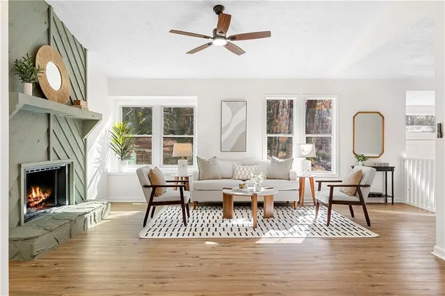 a living room with furniture fireplace and wooden floor