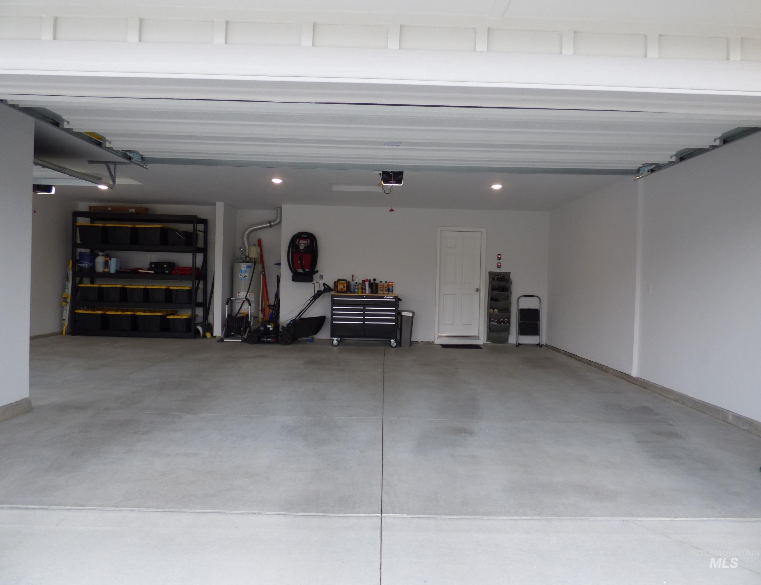 2708 East Buckaroo Drive Kuna, ID 83634 - Photo 33 of 48 Spacious garage with a concrete floor, recessed lighting, and white painted walls