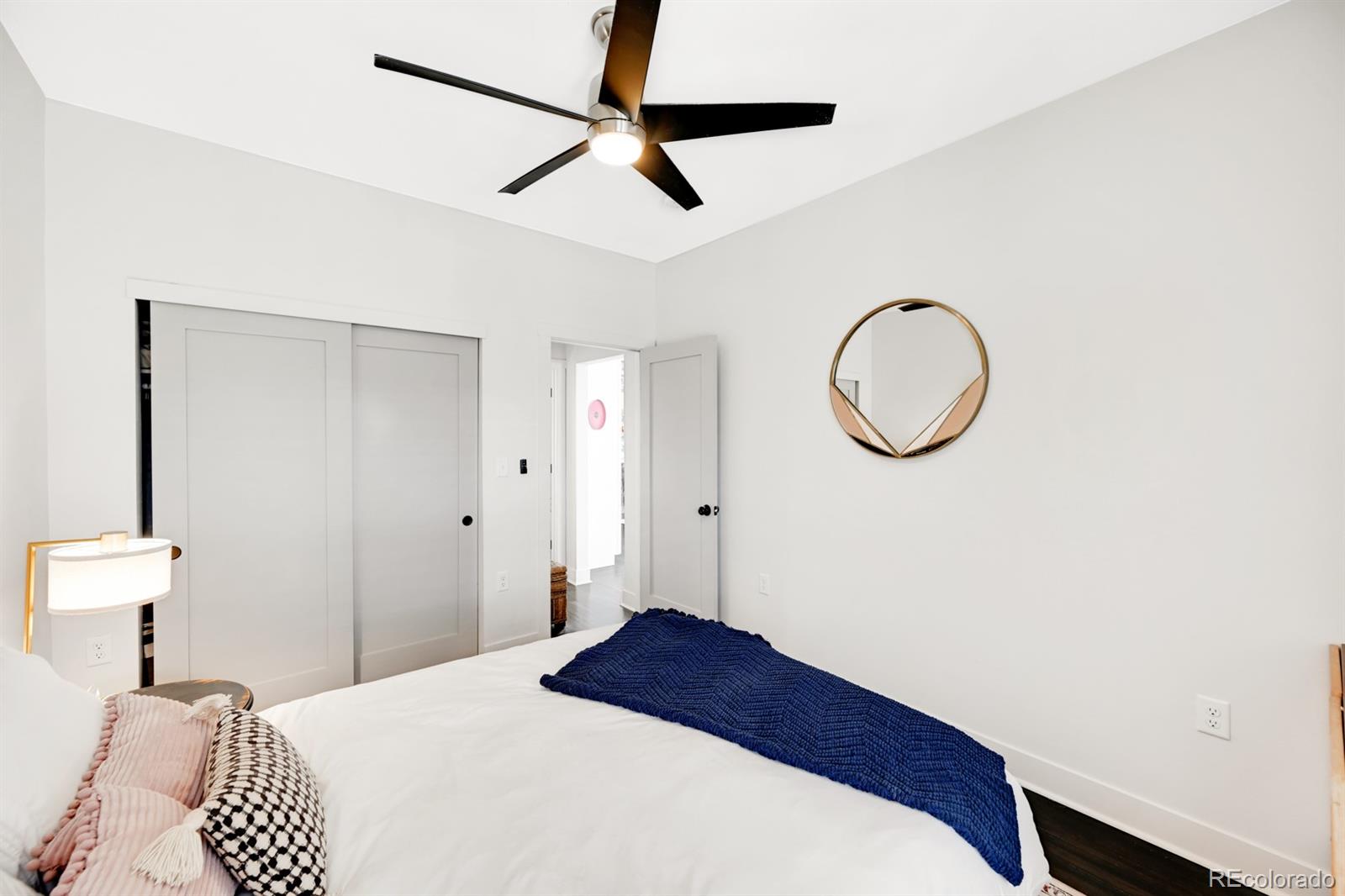 1402 Meade Street Denver, CO 80204 - Photo 13 of 23 a bedroom with a bed and a chandelier