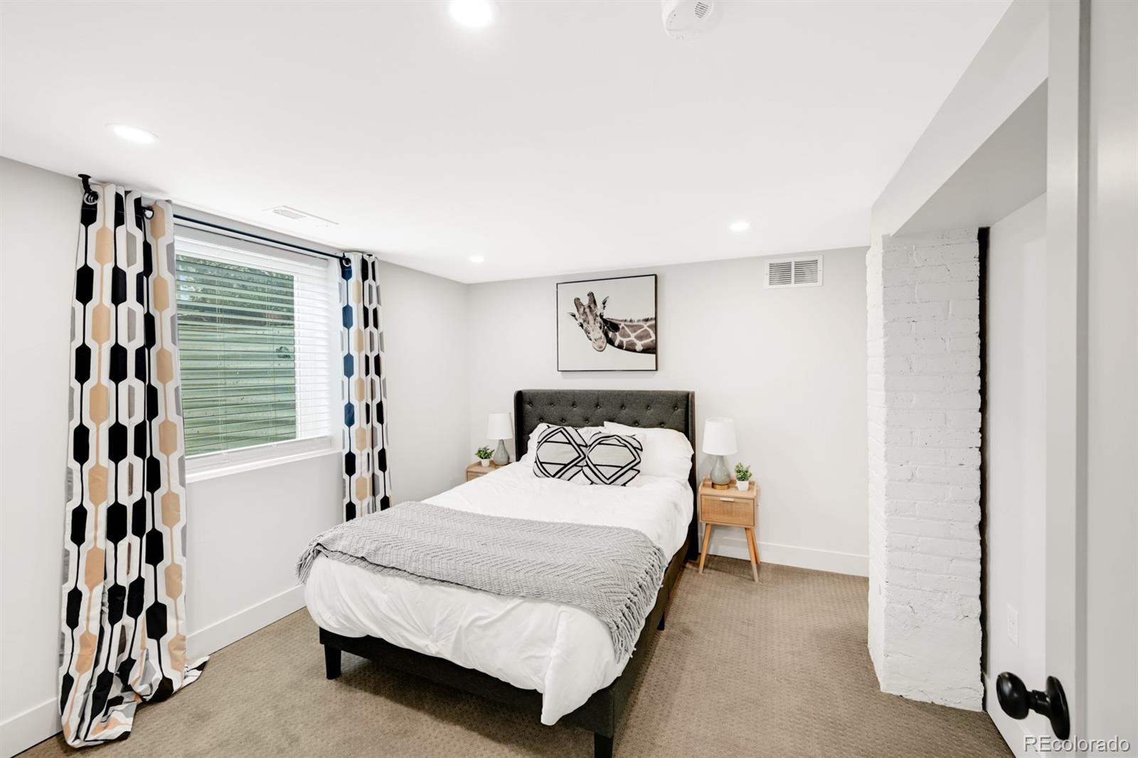 1402 Meade Street Denver, CO 80204 - Photo 16 of 23 a bedroom with a bed and a window