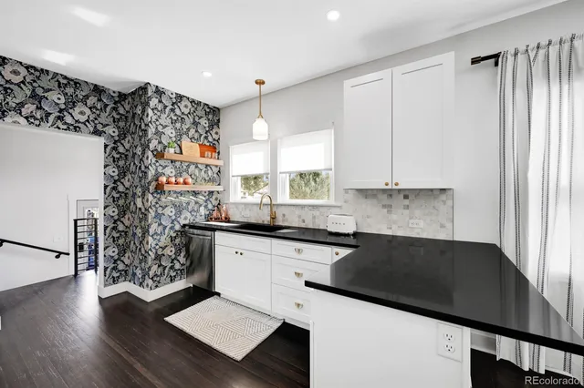 a kitchen with granite countertop a sink and a stove top oven