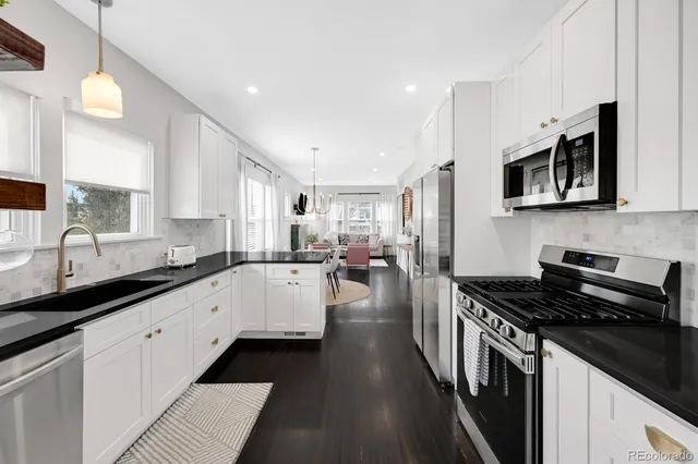 a kitchen with stainless steel appliances a stove sink microwave and cabinets